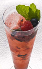 Mixed Berry Mojito - The Mixed Berry Mojito drink is made from cachaca, berries, mint, lime and brown sugar, and served in a highball glass.