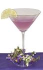 The Purple Blossom cocktail is made from Hpnotiq Harmonie, gin, club soda and lime juice, and served in a chilled cocktail glass.